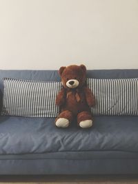 Teddy bear on sofa at home