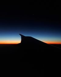 Silhouette of sand against sky at sunset