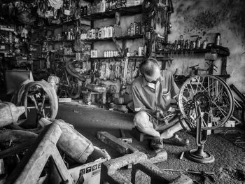 Close-up of man working on wheel