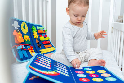 Portrait of boy playing with toy blocks at home