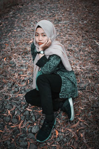 Young woman sitting on field