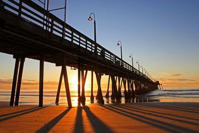 Pier over sea against clear sky