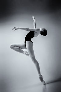 Low section of woman jumping against sky