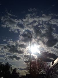 Low angle view of silhouette trees against sky