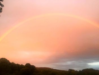 Scenic view of rainbow against sky during sunset