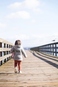 Rear view of boy walking on beach