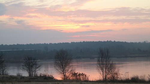 Scenic view of lake against sky during sunset