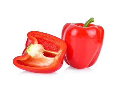 Close-up of red bell peppers against white background