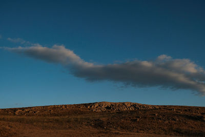 Scenic view of arid landscape against sky