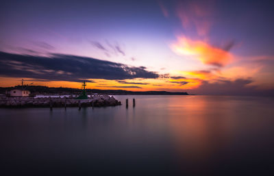 Scenic view of sea against romantic sky at sunset