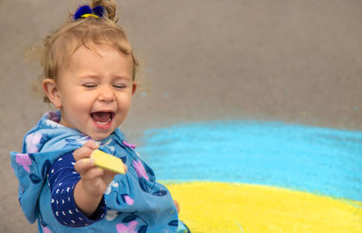 Portrait of cute girl playing with toys