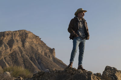 Adult man in cowboy hat in tabernas desert, almeria, spain