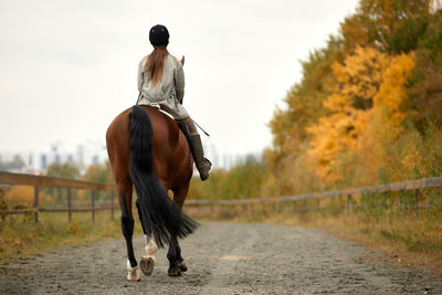 Rear view of woman standing on field