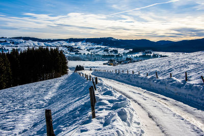 Snow between mountains and valleys with beaten path divided by barbed wire in asiago, vicenza, italy