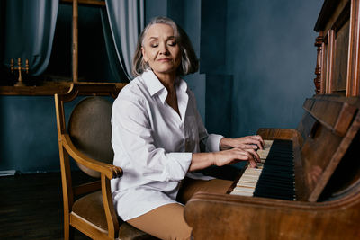 Full length of woman sitting on chair