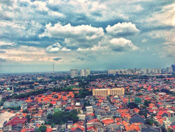 Cityscape against cloudy sky