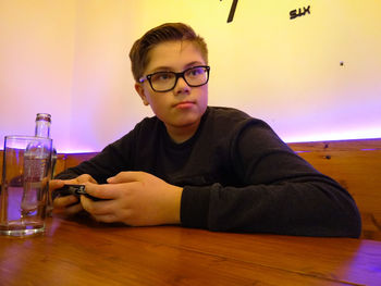 Young man sitting at table