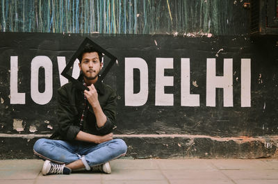 Portrait of young man sitting outdoors