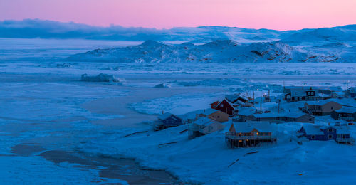 Snow covered landscape against sky