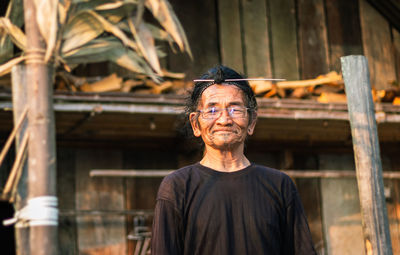 Portrait of smiling senior man standing outdoors