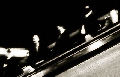 Blurred motion of people walking on road at night