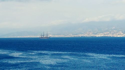 Sailboat sailing on sea against sky