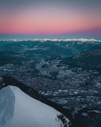 Aerial view of snowcapped mountain against sky during sunset