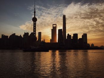 Silhouette of city against sky