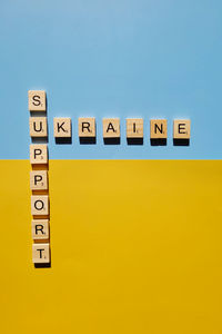 A lot of yellow stickers with words on blue background. concept of  support. stop war in ukraine