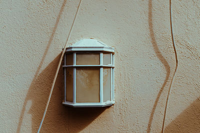 Close-up of electric lamp on wall