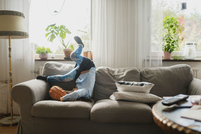 Girl playing on sofa  on the move