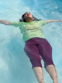 High angle view of woman swimming in pool