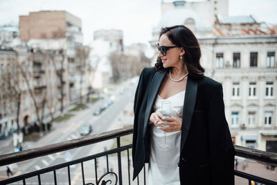 Full length of a beautiful woman drinking glass