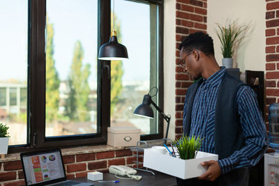 Side view of man using digital tablet in office