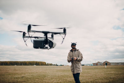 Full length of man standing on field against sky