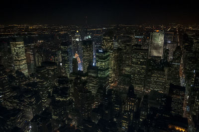 Aerial view of city lit up at night