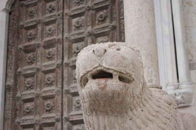 Close-up of statue against historic building