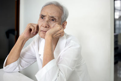 Portrait of man sitting at home