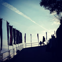 Silhouette people at observation point against sky