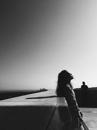 Silhouette of woman against clear sky