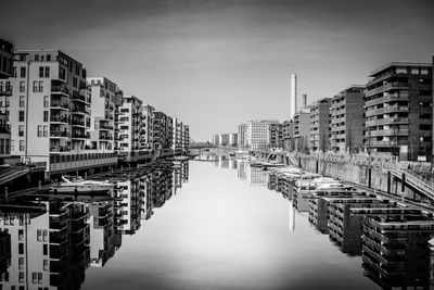 Buildings reflecting on canal in city