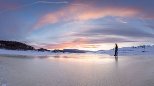 Scenic view of snowcapped mountains against sky during sunset