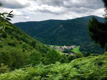 High angle view of green mountains against sky