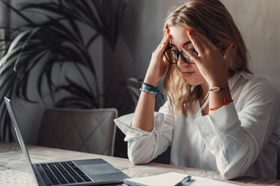 Young woman using mobile phone at office