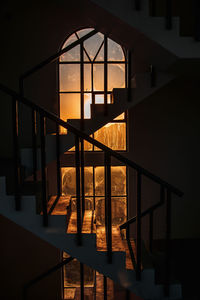 Staircase in dark building during sunset