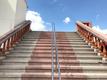 Low angle view of staircase by building against sky