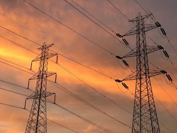 Low angle view of electricity pylon against sky