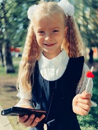 Portrait of smiling girl standing outdoors