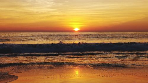 Scenic view of sea against romantic sky at sunset