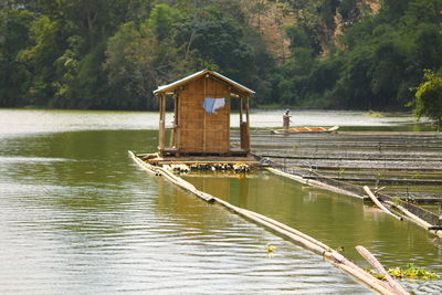 Lifeguard hut in lake against trees